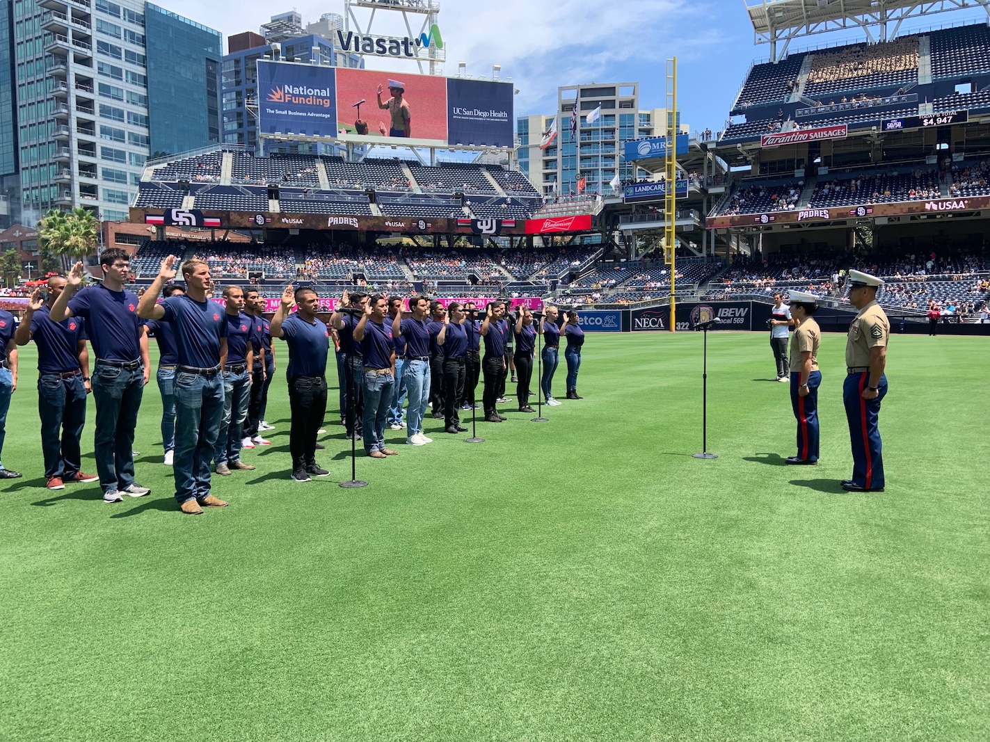 U.S. Marine Corps Capt. Katie Sliwoski, the Executive Officer of Recruiting Station San Diego, conducts the Oath of Enlistment with the RS San Diego poolees at Petco Park, July 28, 2019. The oath of enlistment is a military oath administered by a commissioned officer to any person enlisting or re-enlisting in any branch of service. (U.S. Marine Corps photo by Sgt. Bernadette Plouffe)
