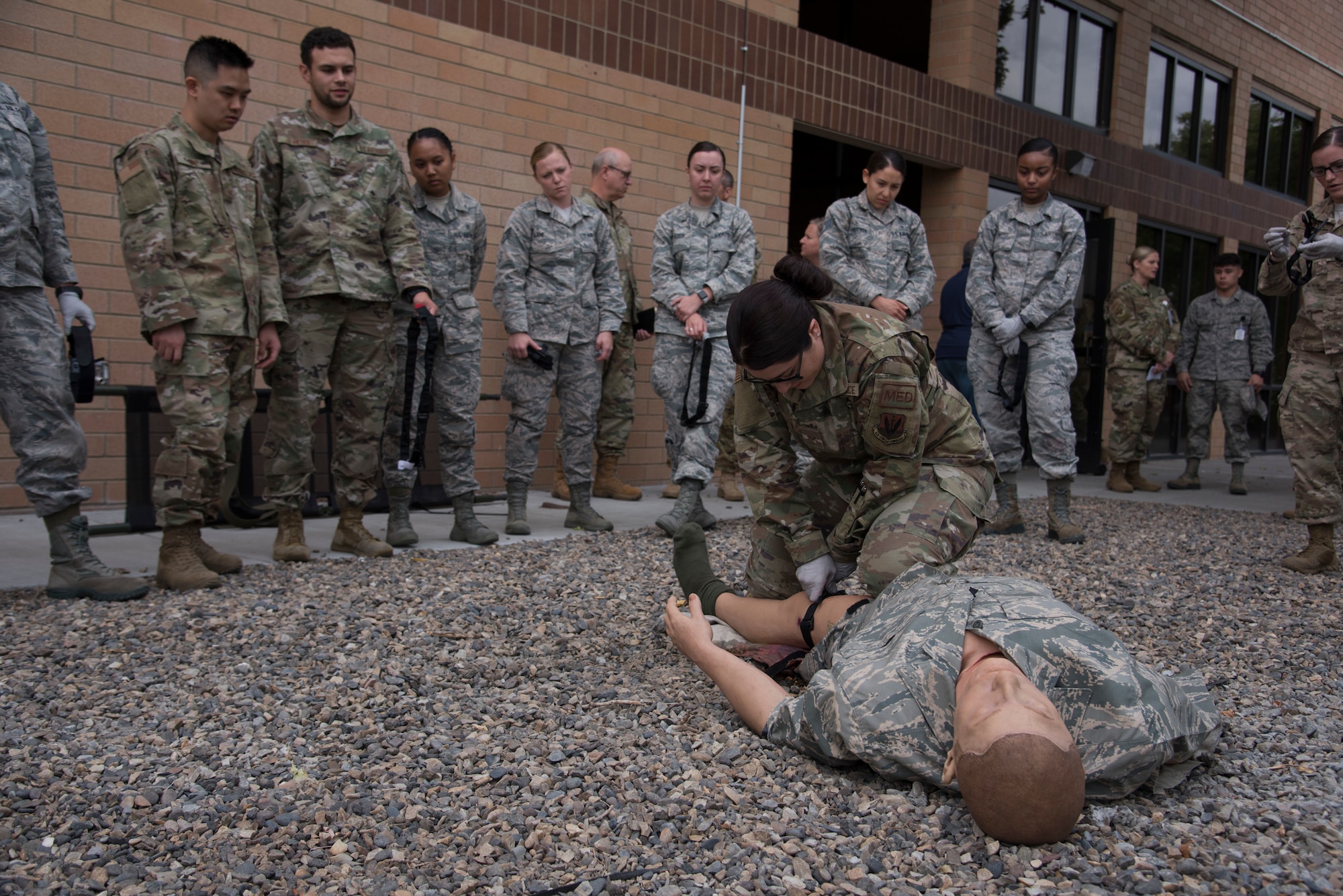 Senior Airman Kierstyn Gunn, 99th Aerospace Medical Squadron aerospace medical service technician, applies a tourniquet to a simulated casualty, Sept 16, 2019, Mountain Home AFB, Idaho. The application of Gunn's knee on the mannequin's leg is to help prevent further bleeding while she applies the tourniquet. (U.S. Air Force Photo by Airman 1st Class Nicholas Swift)