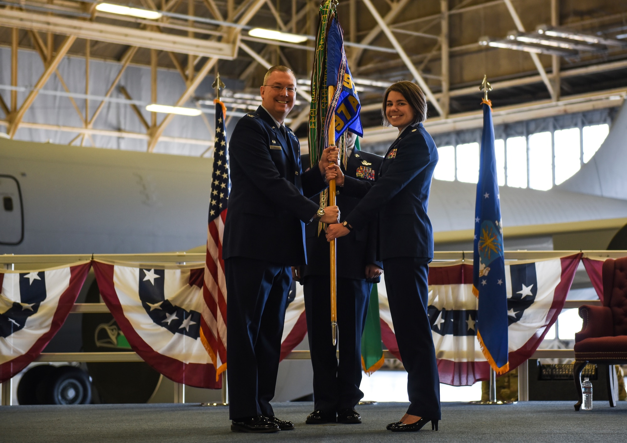 U.S. Air Force Col. Russel Davis, 92nd Operations Group commander, passes the 97th Air Refueling Squadron’s guidon to Lt. Col. Cindy Dawson, 97th ARS incoming commander, during the squadron’s reactivation ceremony and Assumption of Command at Fairchild Air Force Base, Washington Oct. 18, 2019.