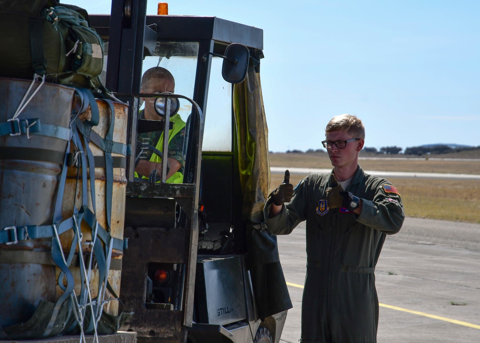 Staff Sgt. Tyler Thomas, a 700th Airlift Squadron loadmaster, directs a Portuguese aerial porter on the flight line at Beja Air Base, Beja, Portugal, during Exercise Real Thaw 2019, Sep. 23, 2019. Real Thaw is a Portuguese-led large joint and combined force exercise held annually where Dobbins supports the aerial functions of the exercise. (U.S. Air Force photo/Senior Airman Justin Clayvon)