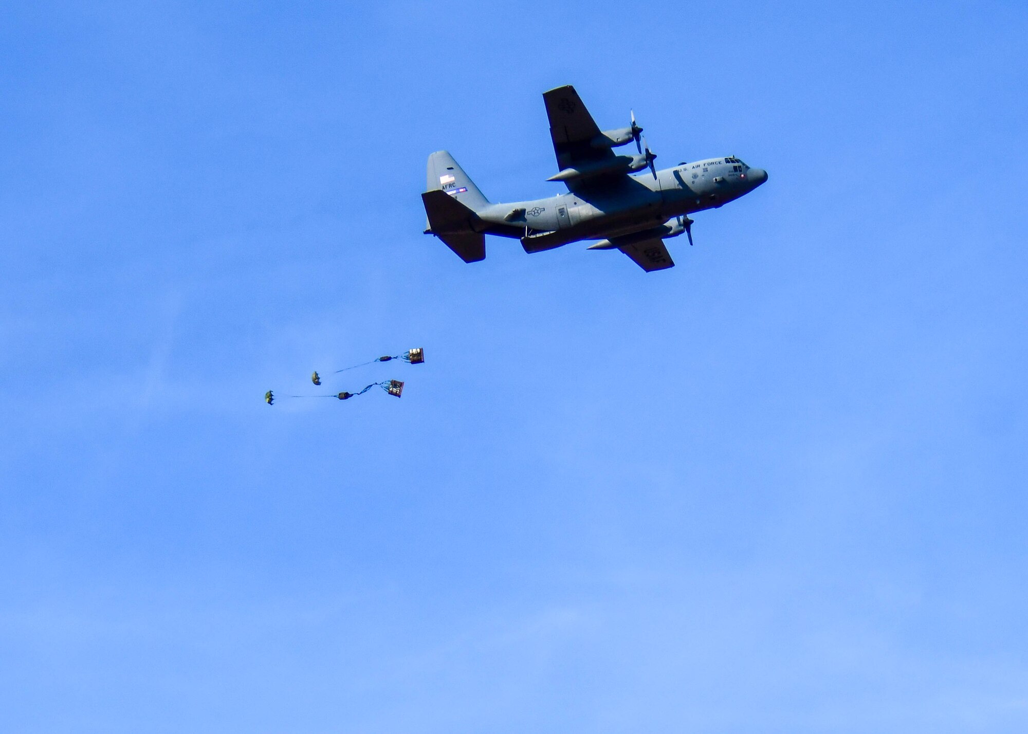 A C-130H3 from Dobbins Air Reserve Base, Georgia, conducts an airdrop near Beja Air Base, Portugal, during Exercise Real Thaw 2019, Sep. 23, 2019. Real Thaw is a Portuguese-led multi-lateral flying training exercise where Dobbins supports the aerial functions of the exercise. (U.S. Air Force photo/Senior Airman Justin Clayvon)