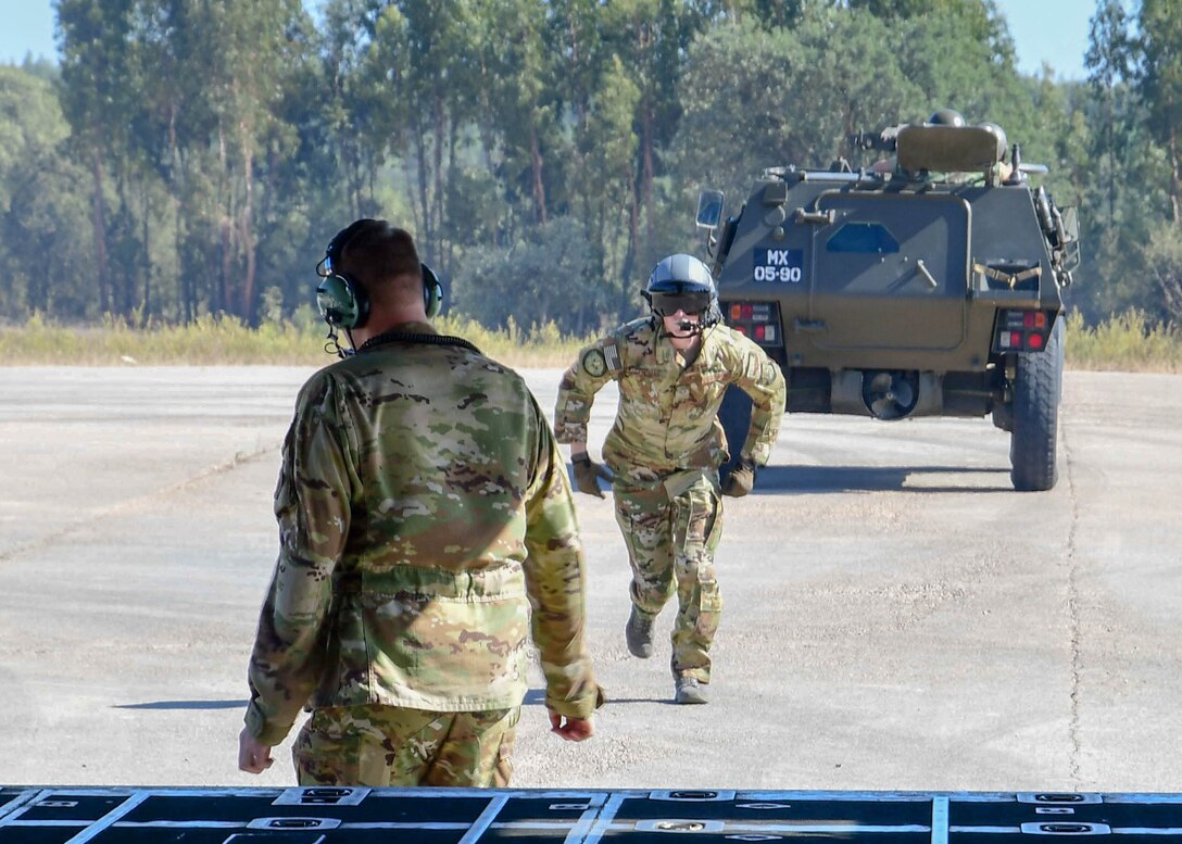 Staff Sgt. Tyler Thomas, a 700th Airlift Squadron loadmaster, runs back to a C-130H3 after assisting with a vehicle drop at a landing zone near Beja Air Base, Portugal,  Sep. 26, 2019 during Exercise Real Thaw 2019. The purpose of the exercise is to execute tactical airlift and air drop operations and training with the Portuguese air force to build interoperability and trust between NATO allies. (U.S. Air Force photo/Senior Airman Justin Clayvon)