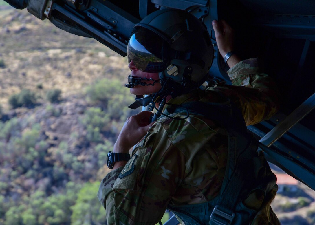 Staff Sgt. Tyler Thomas, a 700th Airlift Squadron loadmaster surveys the scenery from the back of a C-130H3 flying near Beja Air Base, Portugal, Sep. 30, 2019 during Exercise Real Thaw 2019. The purpose of the exercise is to execute tactical airlift and airdrop operations and training with the Portuguese air force where Dobbins supports the aerial functions of the exercise. (U.S. Air Force photo/Senior Airman Justin Clayvon)