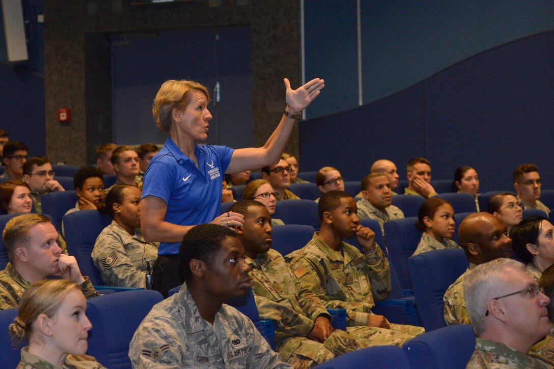 Retired U.S. Air Force Col. Laurel “Buff” Burkel, Air Force Wounded Warrior Program ambassador, points to a slide of the helicopter crash she survived during a resiliency speech at Ramstein Air Base, Germany, Oct. 18, 2019.