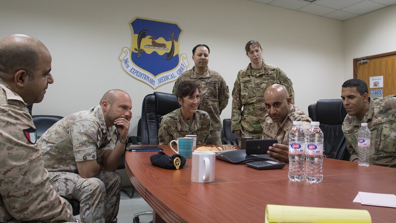 Kuwaiti army Col. (Dr.) Nawaf Jandoul Al-Dousari, second from right, director of the Kuwait Military Medical Complex (North), shares a video highlighting his medical staff with 386th Expeditionary Medical Group leadership and an Italian air force medical staff coalition partner at Ali Al Salem Air Base, Kuwait, Oct. 16, 2019. Al-Dousari, and his colleague, Col. (Dr.) Raed R. Altajalli, left, visited the 386th EMDG clinic to tour the facility, share ideas on improving medical care and discuss strengthening interoperability. (U.S. Air Force photo by Tech. Sgt. Daniel Martinez)