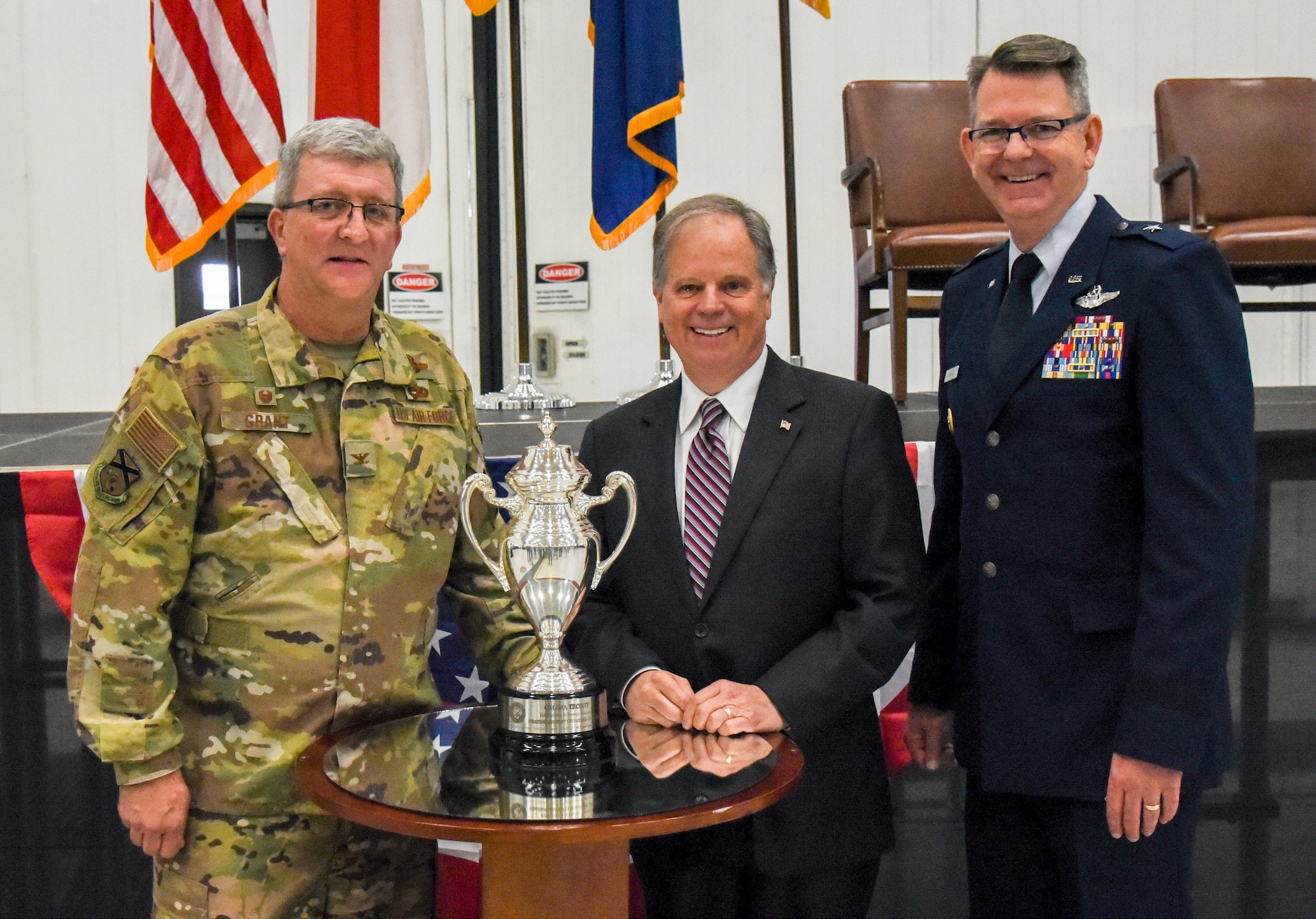 Col. Robert "Scott" Grant, commander, 117 Air Refueling Wing, Sen. Doug Jones and Brig. Gen. James R. Stevenson Jr., Mobilization Assistant to the Director of Operations United States Strategic Command, pose with the Omaha Trophy at Sumpter Smith Air National Guard Base, AL., Oct. 19, 2019.  Jones attended the ceremony and Stevenson presented the trophy celebrating the 117 ARW winning the award having won it in the startegic aircraft category.  The unit was the first Air National Guard tanker unit to win the award(U.S. Air National Guard photo by Master Sgt. Jeremy Farson)