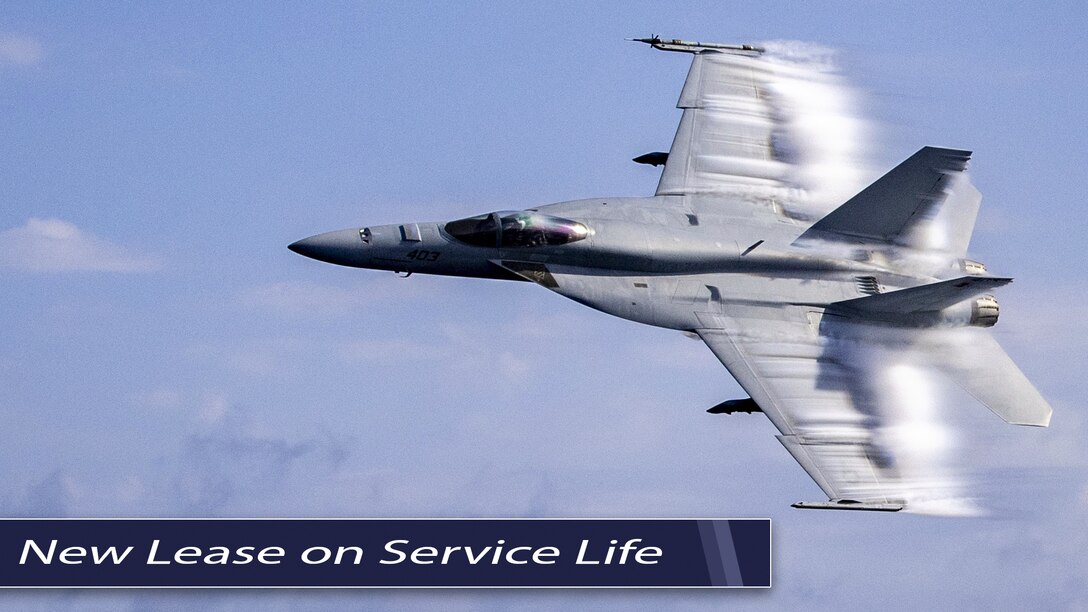 An F/A-18 Super Hornet flies through a blue sky. Text on photo: New Lease on Service Life