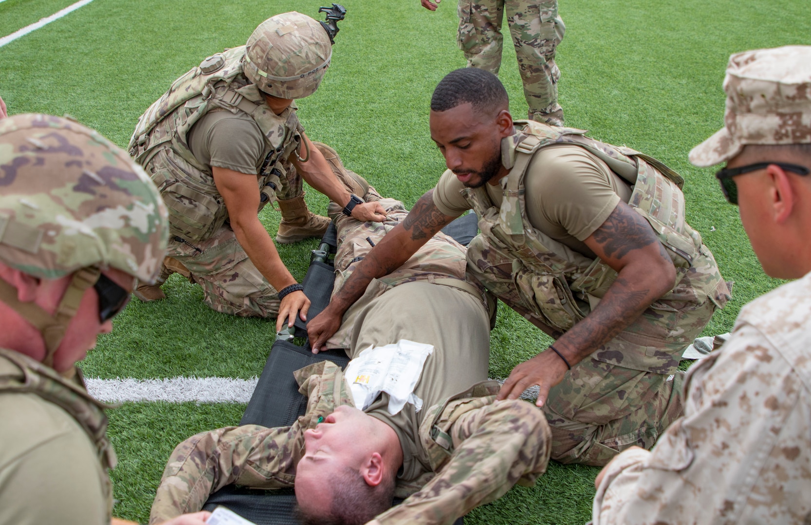 U.S. Army Soldiers roll a simulated casualty onto a litter during the culminating exercise for a Combat Lifesaver Course hosted by combat medics, with 38th Infantry Division, Task Force Spartan, Indiana National Guard, at Joint Training Center-Jordan Oct. 16, 2019.