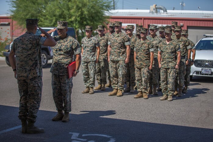U.S. Marines with the Provost Marshalls Office, Headquarters and Headquarters Squadron, Marine Corps Air Station (MCAS) Yuma, are awarded the Navy and Marine Corps Achievement Medal on MCAS Yuma, Oct 2, 2019. The Marines were awarded the Medal for their heroic actions following a traffic accident. (U.S. Marine Corps photo by Lance Cpl John Hall)