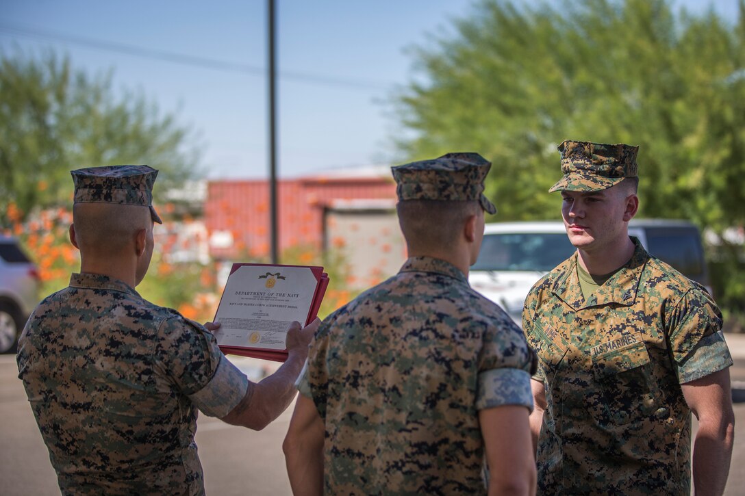 U.S. Marines with the Provost Marshalls Office, Headquarters and Headquarters Squadron, Marine Corps Air Station (MCAS) Yuma, are awarded the Navy and Marine Corps Achievement Medal on MCAS Yuma, Oct 2, 2019. The Marines were awarded the Medal for their heroic actions following a traffic accident. (U.S. Marine Corps photo by Lance Cpl John Hall)