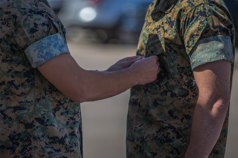 U.S. Marines with the Provost Marshalls Office, Headquarters and Headquarters Squadron, Marine Corps Air Station (MCAS) Yuma, are awarded the Navy and Marine Corps Achievement Medal on MCAS Yuma, Oct 2, 2019. The Marines were awarded the Medal for their heroic actions following a traffic accident. (U.S. Marine Corps photo by Lance Cpl John Hall)