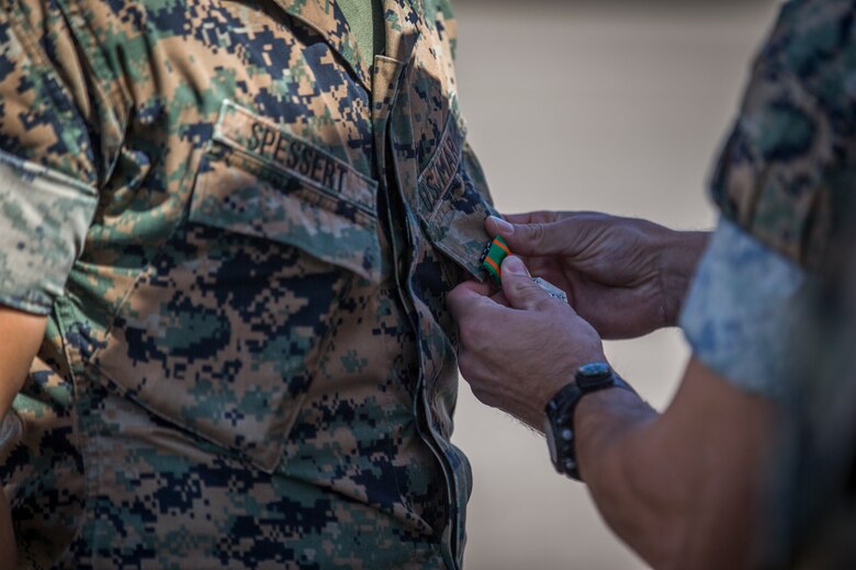 U.S. Marines with the Provost Marshalls Office, Headquarters and Headquarters Squadron, Marine Corps Air Station (MCAS) Yuma, are awarded the Navy and Marine Corps Achievement Medal on MCAS Yuma, Oct 2, 2019. The Marines were awarded the Medal for their heroic actions following a traffic accident. (U.S. Marine Corps photo by Lance Cpl John Hall)