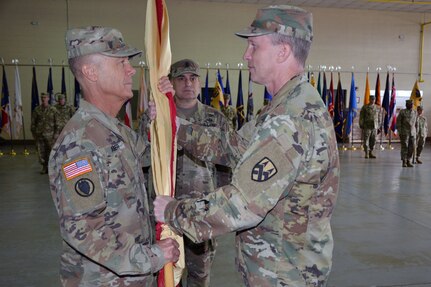 Maj. Gen. Greg Mosser, commanding general of the 377th Theater Sustainment Command, Belle Chasse, La., passes the Army Reserve Sustainment Command’s colors to Brig. Gen. Donald Absher charging him with the responsibility and authority of the ARSC during an Assumption of Command Ceremony on October 20, 2019.