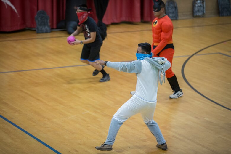 U.S. Marines with Marine Corps Air Station (MCAS) Yuma, compete in the annual "Dodge of the Dead" dodgeball tournament at the gymnasium aboard MCAS Yuma, Ariz., Oct. 15, 2019. The Single Marine Marine Program sponsored event pitted teams of 6 costume clad service members against each other in a fierce competition. (U.S. Marine Corps photo by Lance Cpl John Hall)
