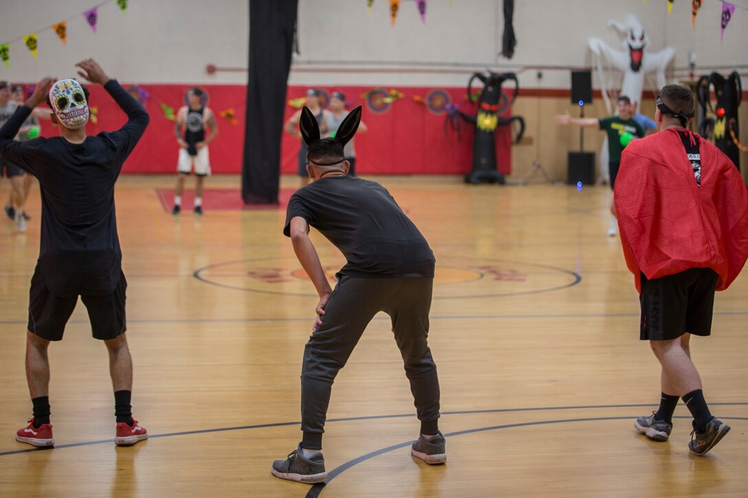 U.S. Marines with Marine Corps Air Station (MCAS) Yuma, compete in the annual "Dodge of the Dead" dodgeball tournament at the gymnasium aboard MCAS Yuma, Ariz., Oct. 15, 2019. The Single Marine Marine Program sponsored event pitted teams of 6 costume clad service members against each other in a fierce competition. (U.S. Marine Corps photo by Lance Cpl John Hall)
