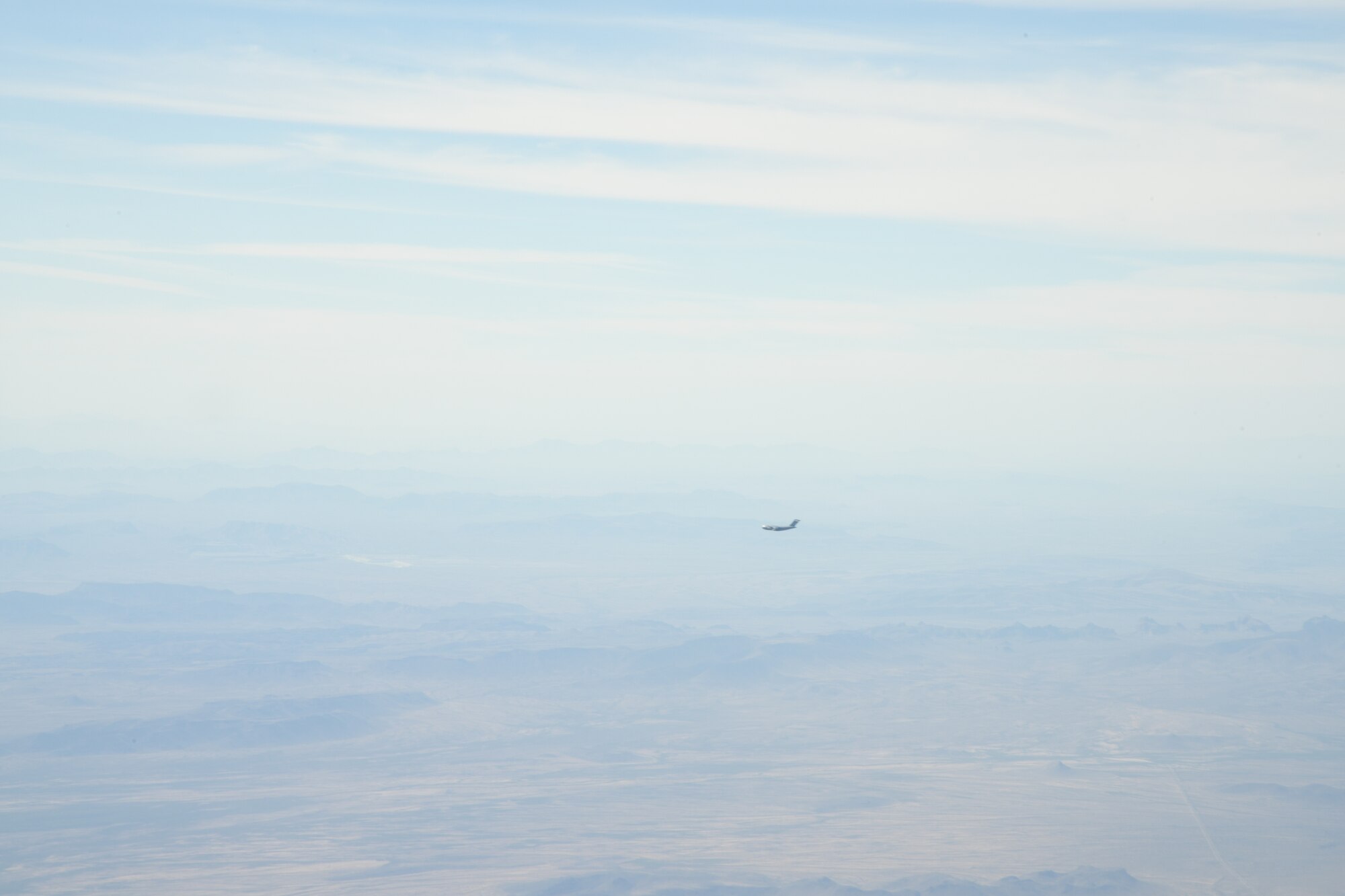 A C-17 Globemaster III from the 21st Airlift Squadron, descends to begin low-altitude training Oct. 16, 2019, at Laguna Army Airfield in Yuma Proving Ground, Ariz. Pilots from the 3AS, Dover Air Force Base, Del., and 21st Airlift Squadron, Travis Air Force Base, Calif., conducted low-altitude training during Weapons and Tactics Instructor Course 1-20. WTI is a seven-week training event hosted by Marine Aviation Weapons and Tactics Squadron One, which emphasizes operational integration of the six functions of Marine Corps aviation in support of a Marine Air Ground Task Force. (U.S. Air Force Photo by Tech Sgt. Esteban Esquivel)