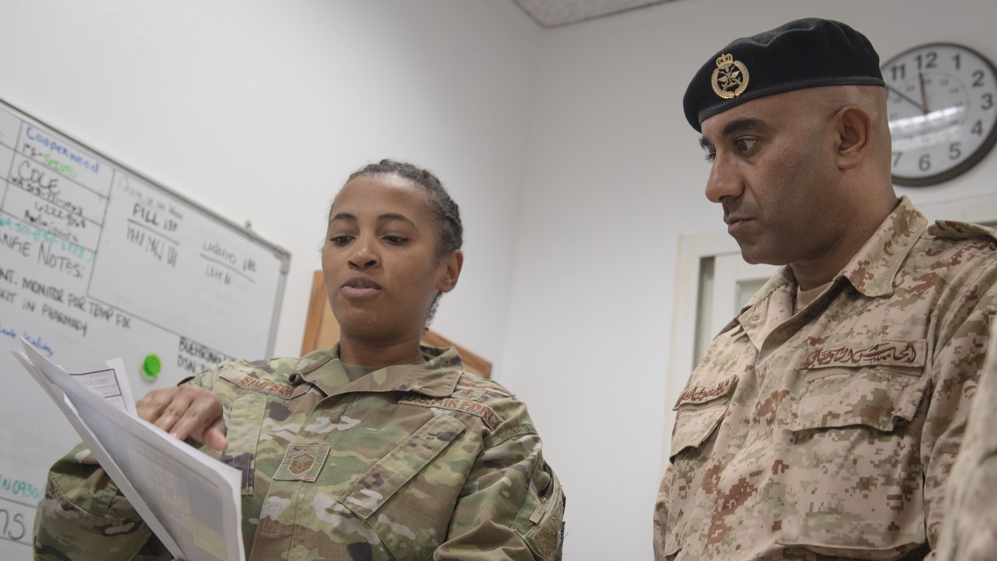 U.S. Air Force Master Sgt. Yaneesa Simpson, 386th Expeditionary Medical Group medical technician, explains the 9-line medevac request process to Kuwait army Col. Nawaf Jandoul Al-Dousari, North Military Medical Complex director, during his tour of the 386th EMDG clinic at Ali Al Salem Air Base, Kuwait, Oct. 16, 2019. The Kuwait army directors of the North Military Medical Complex visited the 386th EMDG clinic to tour the facility, share ideas on improving medical care and discuss strengthening interoperability. (U.S. Air Force photo by Tech. Sgt. Daniel Martinez)