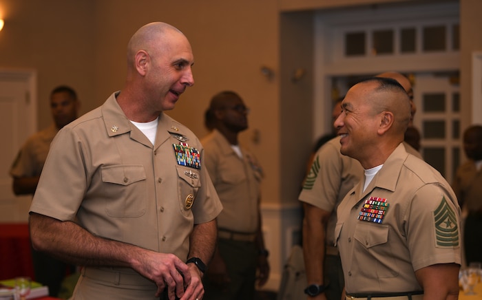 Navy Command Master Chief Christopher W. Moore and Marine Corps Sgt. Maj. Peter A. Siaw speak during the Sergeant Major of the Marine Corps Symposium in Quantico, Va., Oct. 17, 2019. The Sergeant Major of the Marine Corps Symposium is an annual event for Marine Corps Sergeants Major to gather and discuss Corps readiness, safety and future operations.