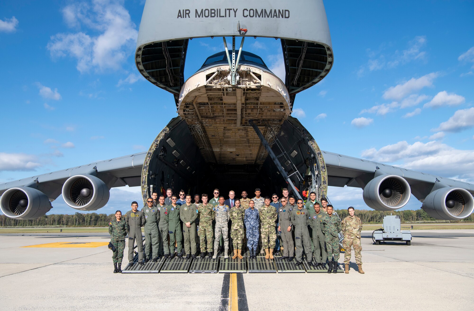 Latin American cadets, hosts from the Secretary of the Air Force's office of international affairs and personnel from the 436th Airlift Wing pose in front of a C-5M Super Galaxy during a tour of the aircraft Oct. 17, 2019, at Dover Air Force Base, Del. The Latin American Cadet Initiative program was originally created in 2006 by the Office of the Secretary of the Air Force for International Affairs. (U.S. Air Force photo by Senior Airman Christopher Quail)