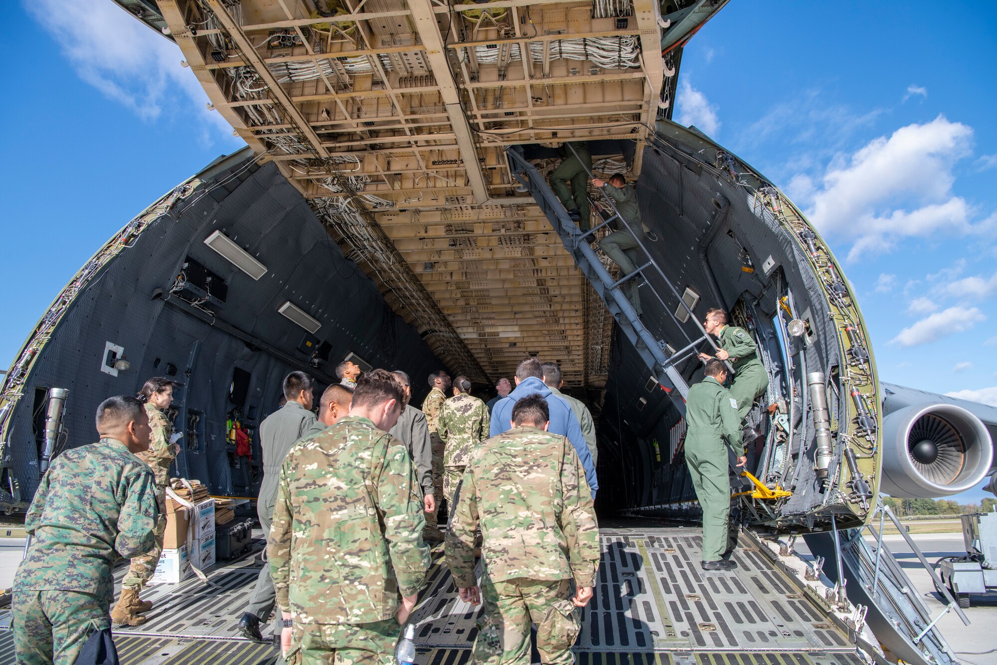 Cadets from the Latin American Cadet Initiative climb the troop compartment stairs on a C-5M Super Galaxy during their visit Oct. 17, 2019, at Dover Air Force Base, Del. The cadets were transported to the flight line to tour a static C-5M Super Galaxy after the briefings in the 3rd Airlift Squadron auditorium. (U.S. Air Force photo by Senior Airman Christopher Quail)