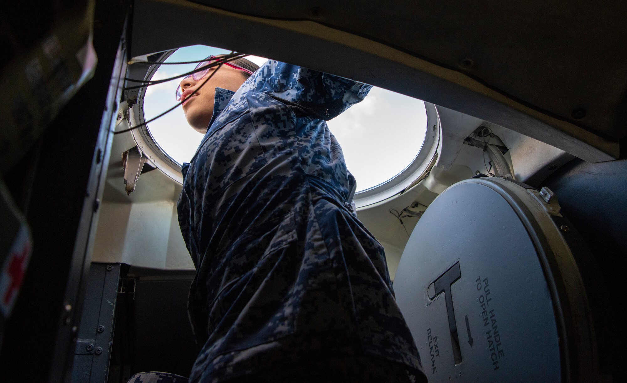 Beatriz Rosette Rivera, Mexican cadet, looks out of a C-5M Super Galaxy Number 1 Escape Hatch during their visit Oct. 17, 2019, to Dover Air Force Base, Del. Two of the top senior cadets were selected from 11 different Latin American air force academies to attend the Latin American Cadet initiative. (U.S. Air Force photo by Senior Airman Christopher Quail)