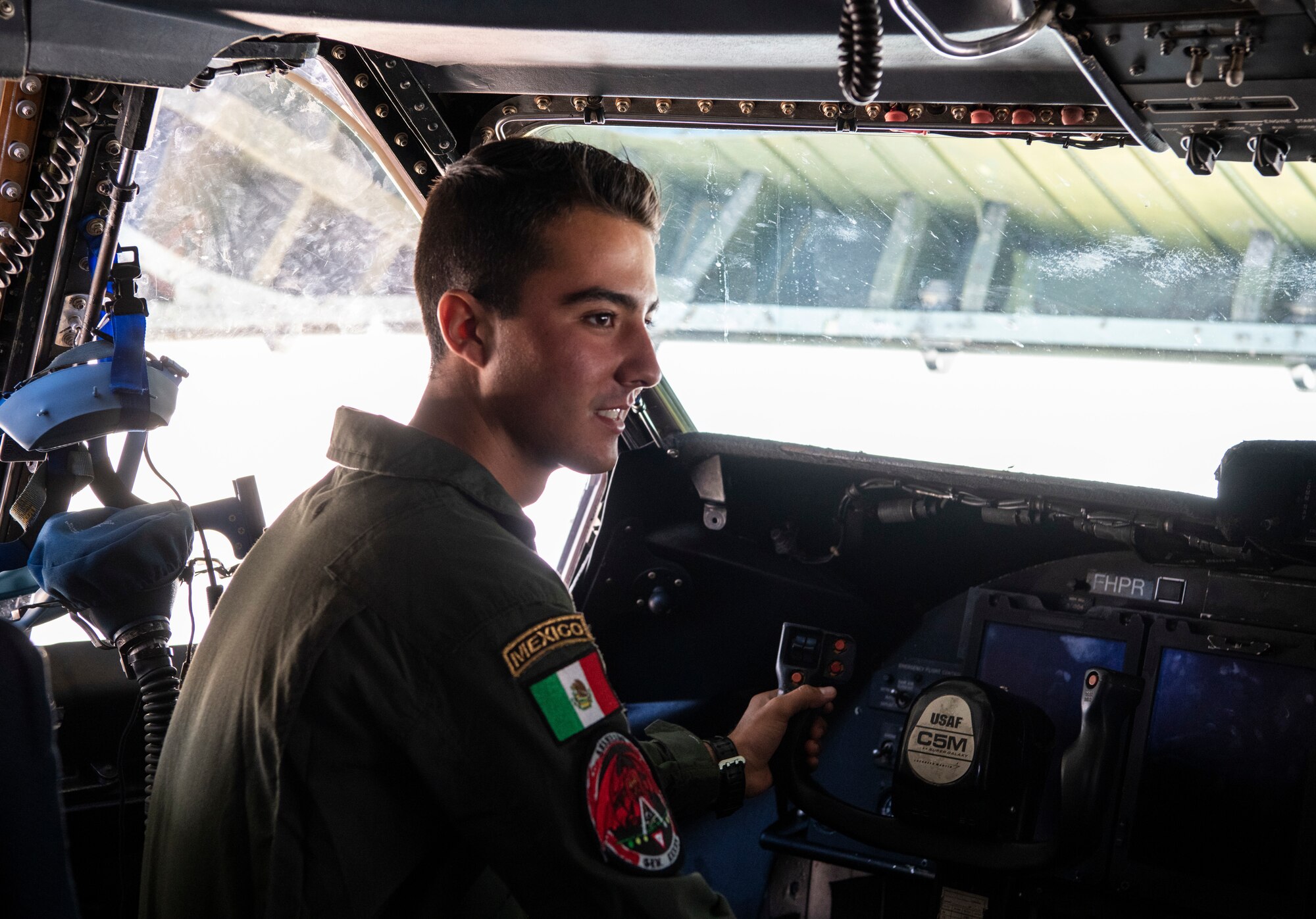 Jose de Jesus Duenas Garcia, Mexican cadet, sits in the pilot seat of a C-5M Super Galaxy during their visit Oct. 17, 2019, at Dover Air Force Base, Del. The C-5M Super Galaxy is equipped with 28 wheels, four commercial engines and five sets of landing gear. (U.S. Air Force photo by Senior Airman Christopher Quail)