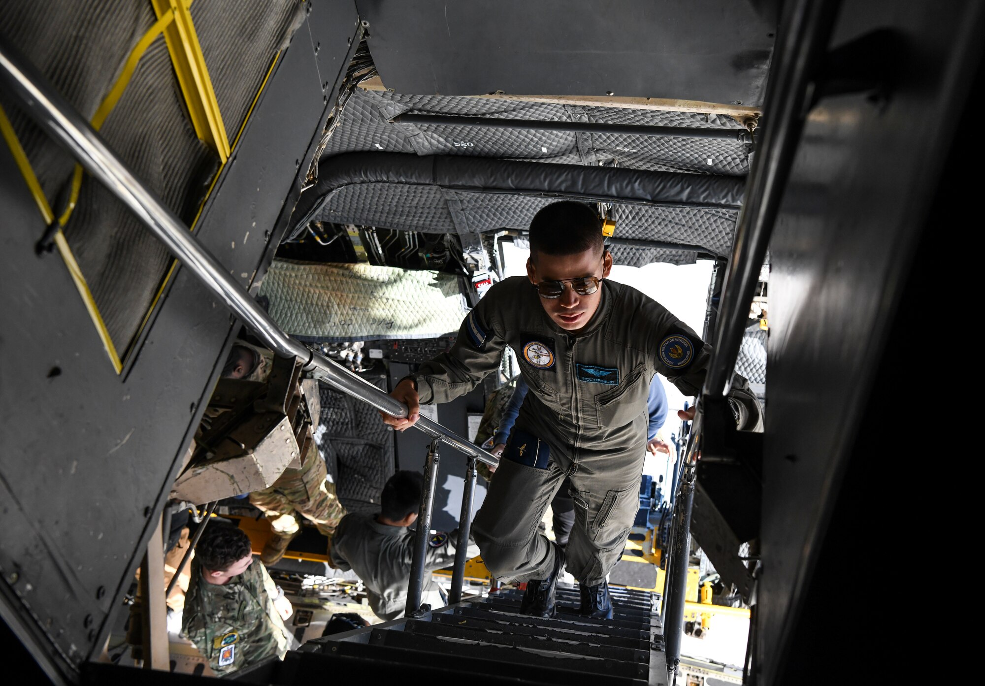 A Honduran cadet climbs the troop compartment stairs on a C-5M Super Galaxy during their visit Oct. 17, 2019, at Dover Air Force Base, Del. The aircraft can fly 2,150 nautical miles with a cargo load of 281,001 pounds. (U.S. Air Force photo by Senior Airman Christopher Quail)