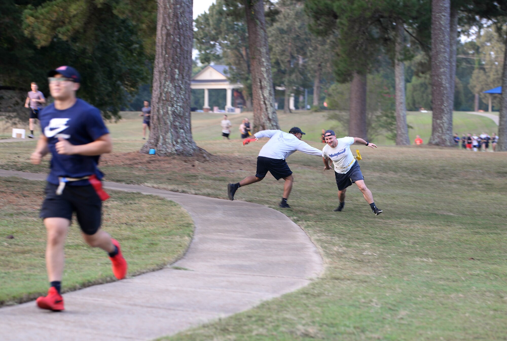 Participants dodge zombie attacks at the Zombie Fun Run Sept. 27, 2019, along the BLAZE Fit Trail on Columbus Air Force Base, Miss. Runners wore a belt with flags in a challenge to escape the zombie infested zones along the 2 mile trail. (U.S. Air Force photo by Airman 1st Class Hannah Bean)