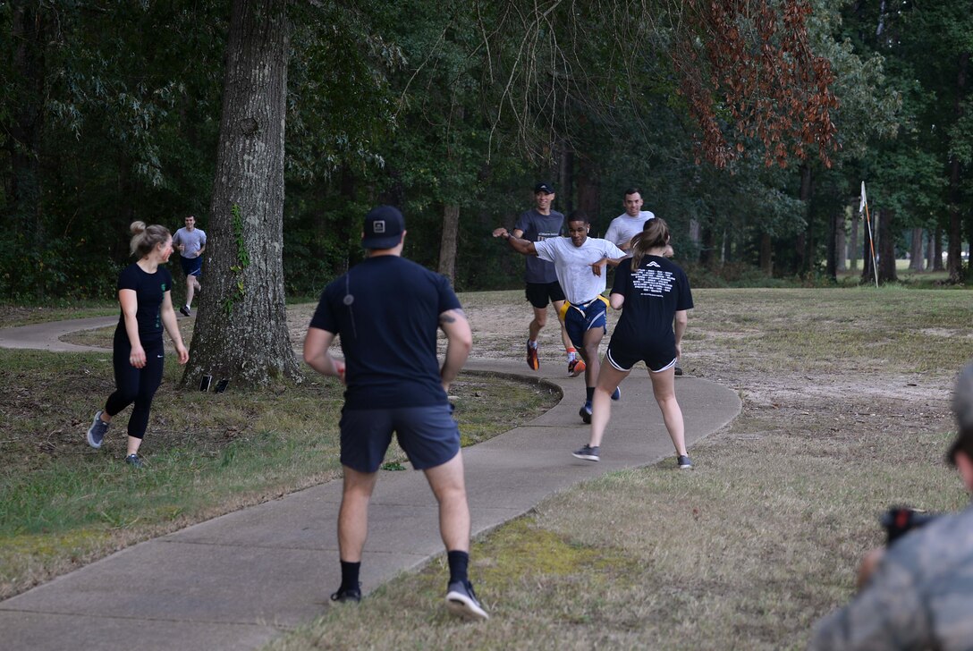 Participants run though zombie stations at the Zombie Fun Run Sept. 27, 2019, along the BLAZE Fit Trail on Columbus Air Force Base, Miss. Runners were provided donuts, Gatorade, and water by the 14th Civil Engineer Squadron Readiness and Emergency Management Flight and Red Cross after the run. (U.S. Air Force photo by Airman 1st Class Hannah Bean)