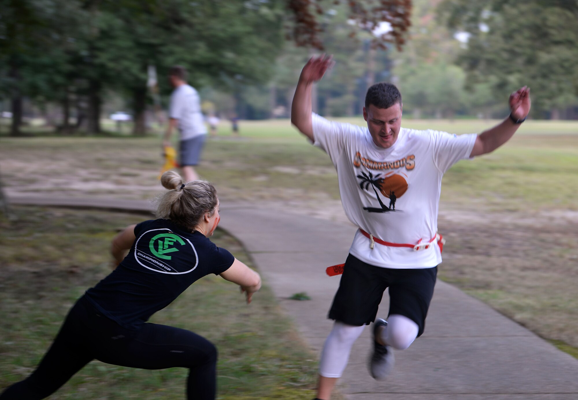 A participant dodges a zombie attack at the Zombie Fun Run Sept. 27, 2019, along the BLAZE Fit Trail on Columbus Air Force Base, Miss. To close out National Preparedness Month, runners raced along the trail with a flag-football style belt in a challenge to escape the zombie infected zones. (U.S. Air Force photo by Airman 1st Class Hannah Bean)
