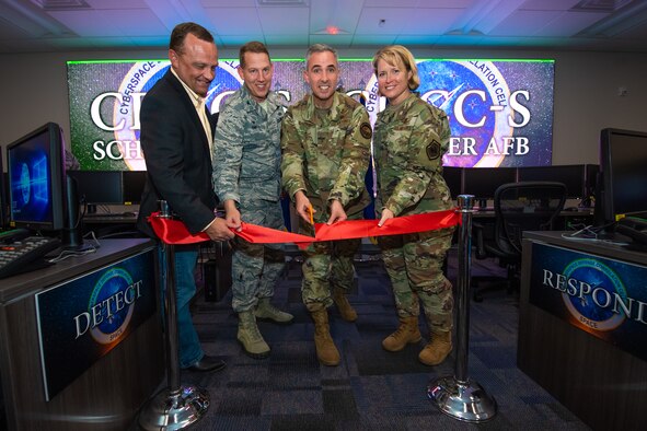 From left, retired Col. Jason Sutton, former 50th Network Operations Group commander; Col. James Smith, 50th Space Wing commander; Maj. Gen. Stephen Whiting, 14th Air Force commander; and Brig. Gen. Deanna Burt, Air Force Space Command director of operations and communications, cut a ribbon signifying the standup of the Cyber Defense Correlation Cell for Space at Schriever Air Force Base, Colorado, Oct. 18, 2019. The CDCC-S is the first of its kind in the Air Force and will detect and respond to cyber threats against AFSPC mission systems. (U.S. Air Force photo by Kathryn Calvert)