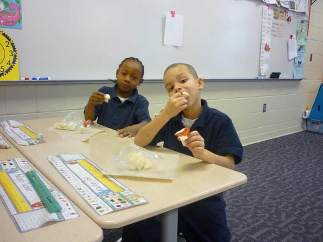 Students at E. J. Brown Elementary School in Dayton, Ohio, eat cauliflower with low fat ranch dip, as part of their school’s Fresh Fruit and Vegetable Program. This school is one of the 45,000 schools that receives fresh fruits and vegetables through a partnership between DLA Troop Support and the USDA National School Lunch program. (Courtesy Photo by United States Department of Agriculture)