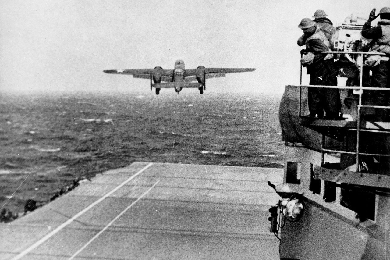 A plane takes off from the flight deck of a carrier.