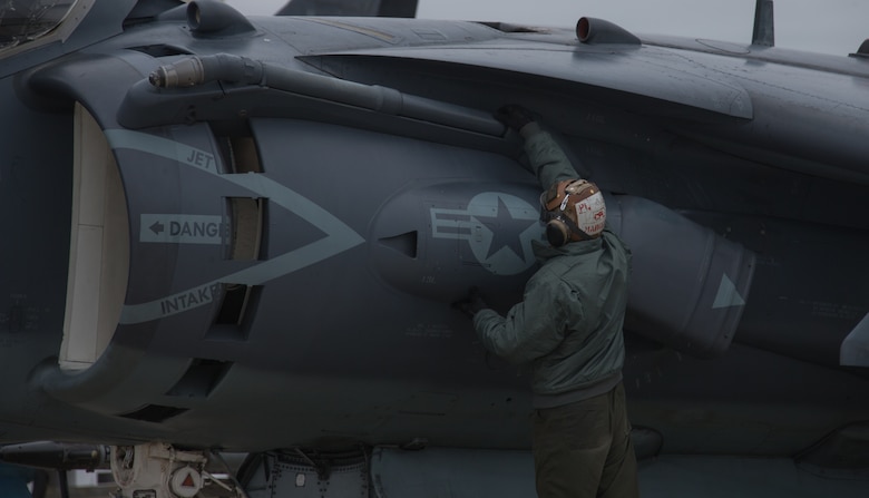 Cpl. Johnathan Marquez performs pre-flight checks on an AV-8B II Harrier attack jet before a training mission with the 175th Fighter Squadron, 114th Fighter Wing of the South Dakota Air National Guard at Joe Foss Field, Sioux Falls, South Dakota Oct. 4, 2019. Marine Attack Squadron 231 and the 114th FW are participating in force-on-force training consisting of simulated air-to-air combat and air-to-ground strikes to enhance interoperability and readiness. Marquez is a fixed-wing aircraft mechanic from VMA-231. (U.S. Marine Corps photo by Lance Cpl. Gavin Umboh)
