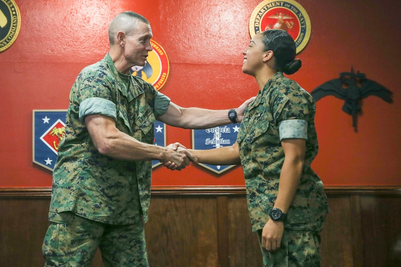 U.S. Marine Corps Maj. Gen. Stephen Neary (Left), the commanding general of 2nd Marine Expeditionary Brigade, shakes hands with Pfc. Leslie Bowie, a logistics embarkation specialist with 2nd MEB, G-4, during the Maritime Preposition Force Staff Planning Course at Camp Lejeune, N.C., Oct. 11, 2019. This training course is intended to help align II Marine Expeditionary Force and 2nd Marine Expeditionary Brigade with the Commandant’s Planning Guidance. (U.S. Marine Corps photo by Cpl. Stephen Campbell)