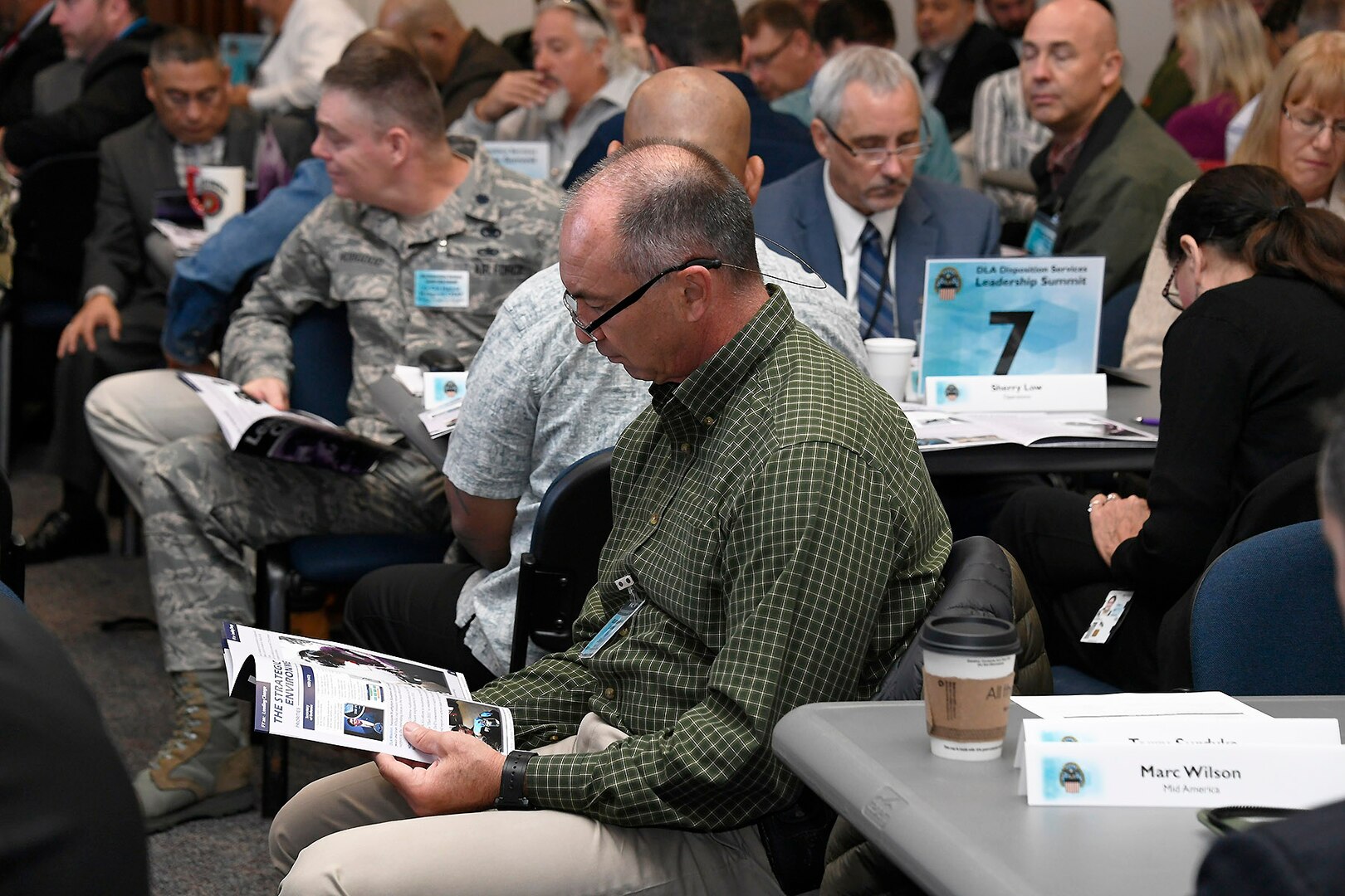 An attendee follows along as strategic planning information is discussed.