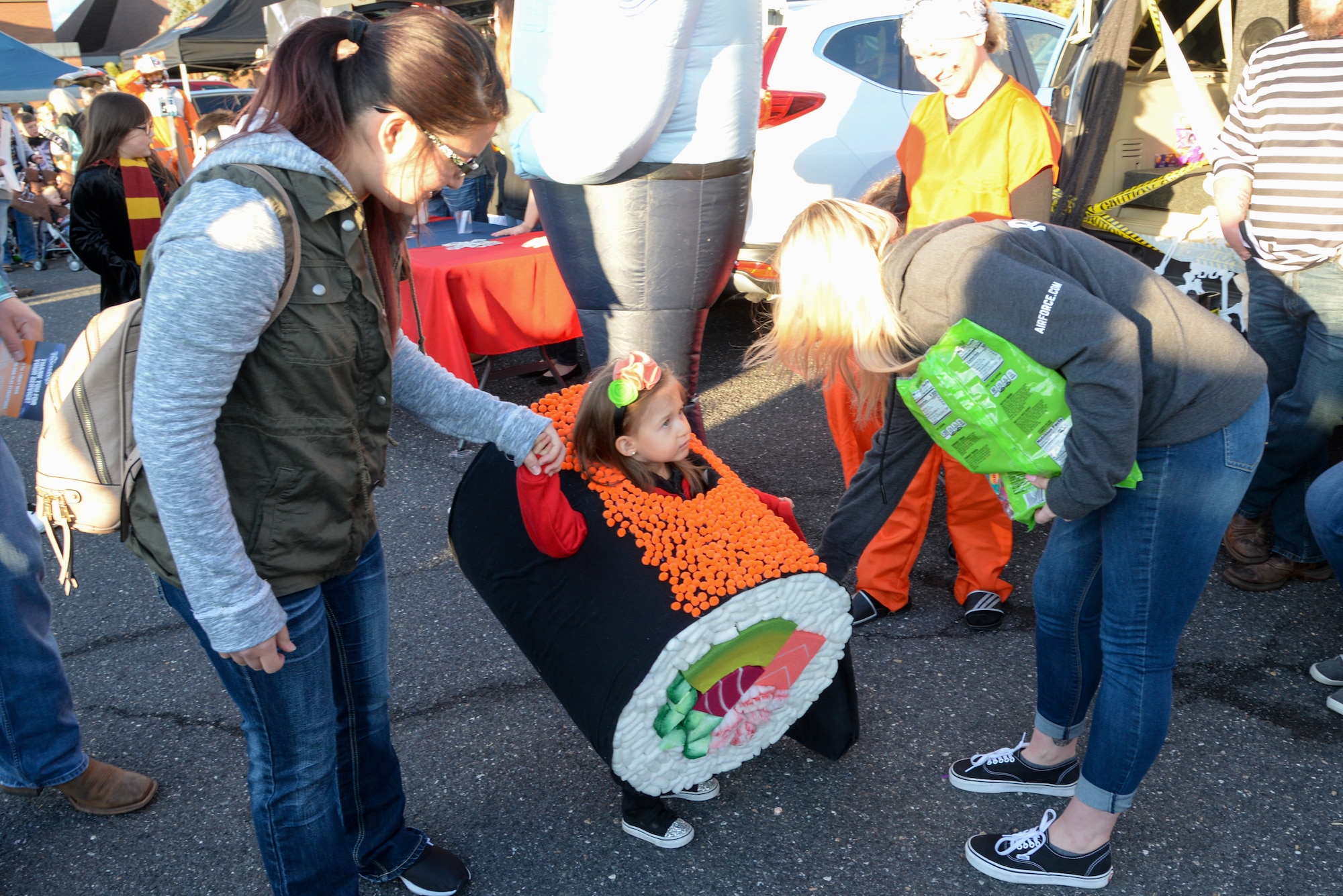 Miya Suiter in homemade sushi costume, and her mother, Laura, receive candy during the annual Haunting on the Hill celebration Oct. 18, 2019, at Hill Air Force Base, Utah. The event is organized by the 75th Force Support Squadron. (U.S. Air Force photo by Cynthia Griggs)