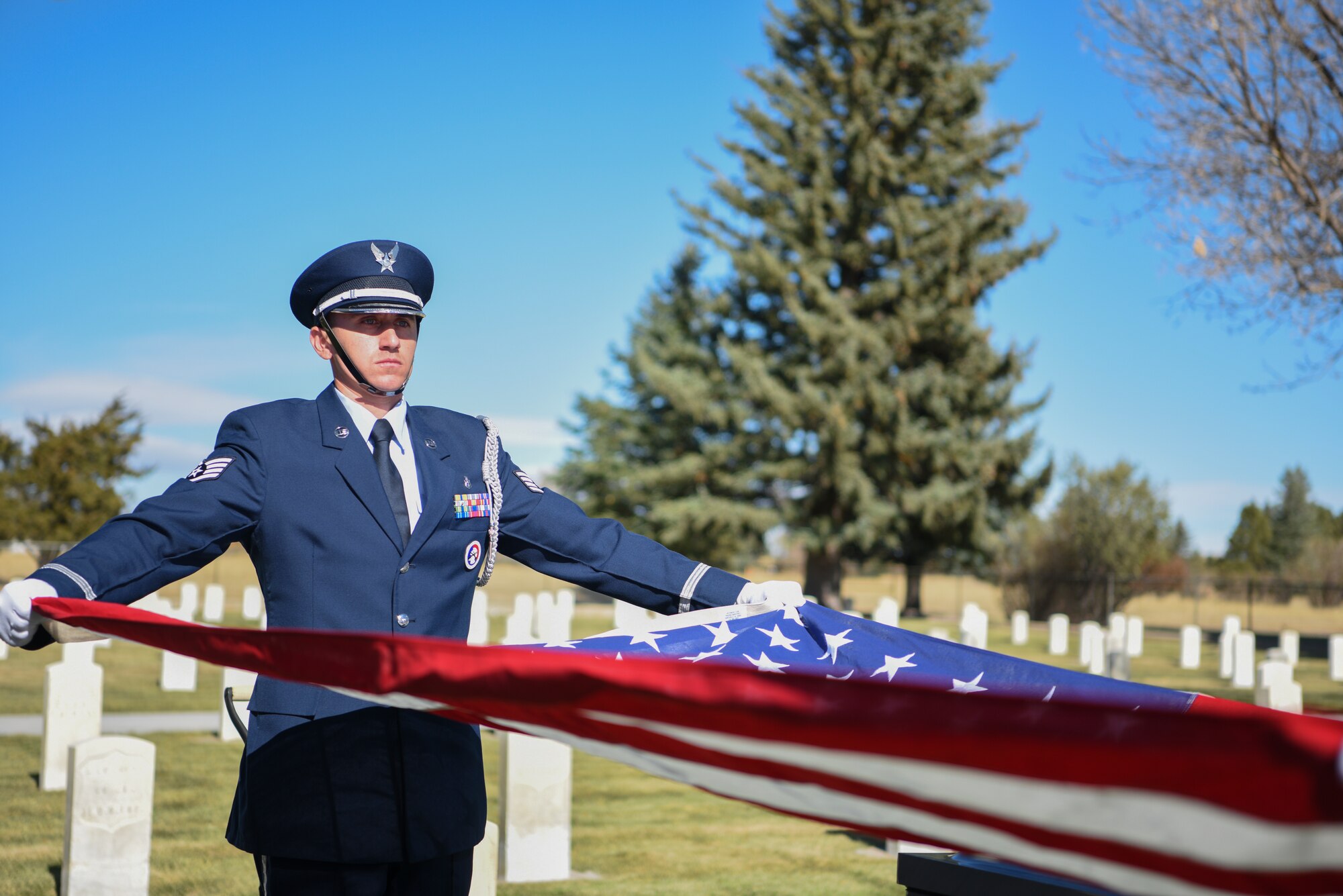 Base Honor Guard fold an American flag for retired Master Sgt. Robert Meadows on Oct. 22, 2019, on F.E. Warren Air Force Base, Wyo. While serving, Meadows provided high precision geospatial and geophysical information for defense and intelligence needs around the world. (U.S. Air Force photo by Senior Airman Nicole Reed)