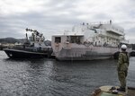 YOKOSUKA, Japan (Oct. 10, 2019) Boatswains Mate 2nd Class Christie Welter, a dock master assigned to Commander, Fleet Activities Yokosuka’s (CFAY) Port Operations Department, observes the Valiant-class harbor tug Menominee (YT 807) as it assists the non-self-propelled Barracks Ship USS Nueces (APL 40) into a dry-dock in preparation for Super Typhoon Hagibis. CFAY provides, maintains, and operates base facilities and services in support of U.S. 7th Fleet's forward-deployed naval forces, 71 tenant commands, 27,000 military and civilian personnel and families.