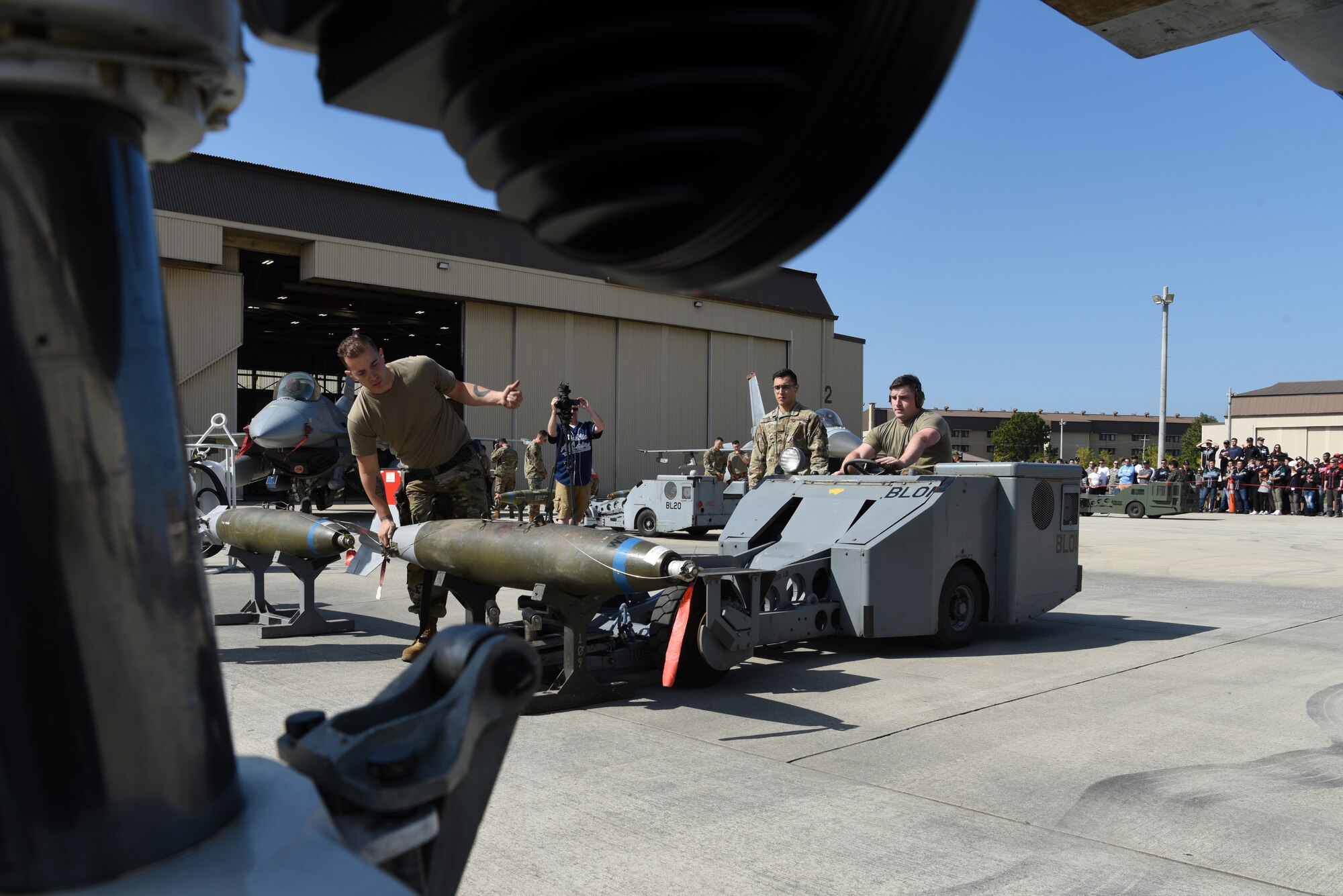 Members of the 36th Aircraft Maintenance Unit, Osan Air Base, Republic of Korea, load a bomb onto an F-16 Fighting Falcon aircraft during the 2019 Penn Fest competition at Kunsan Air Base, ROK, Oct. 19, 2019. The 38th FG AMU competed against four U.S. Air Force teams and completed their loads with the second quickest times. (U.S. Air Force photo by Staff Sgt. Joshua Edwards)