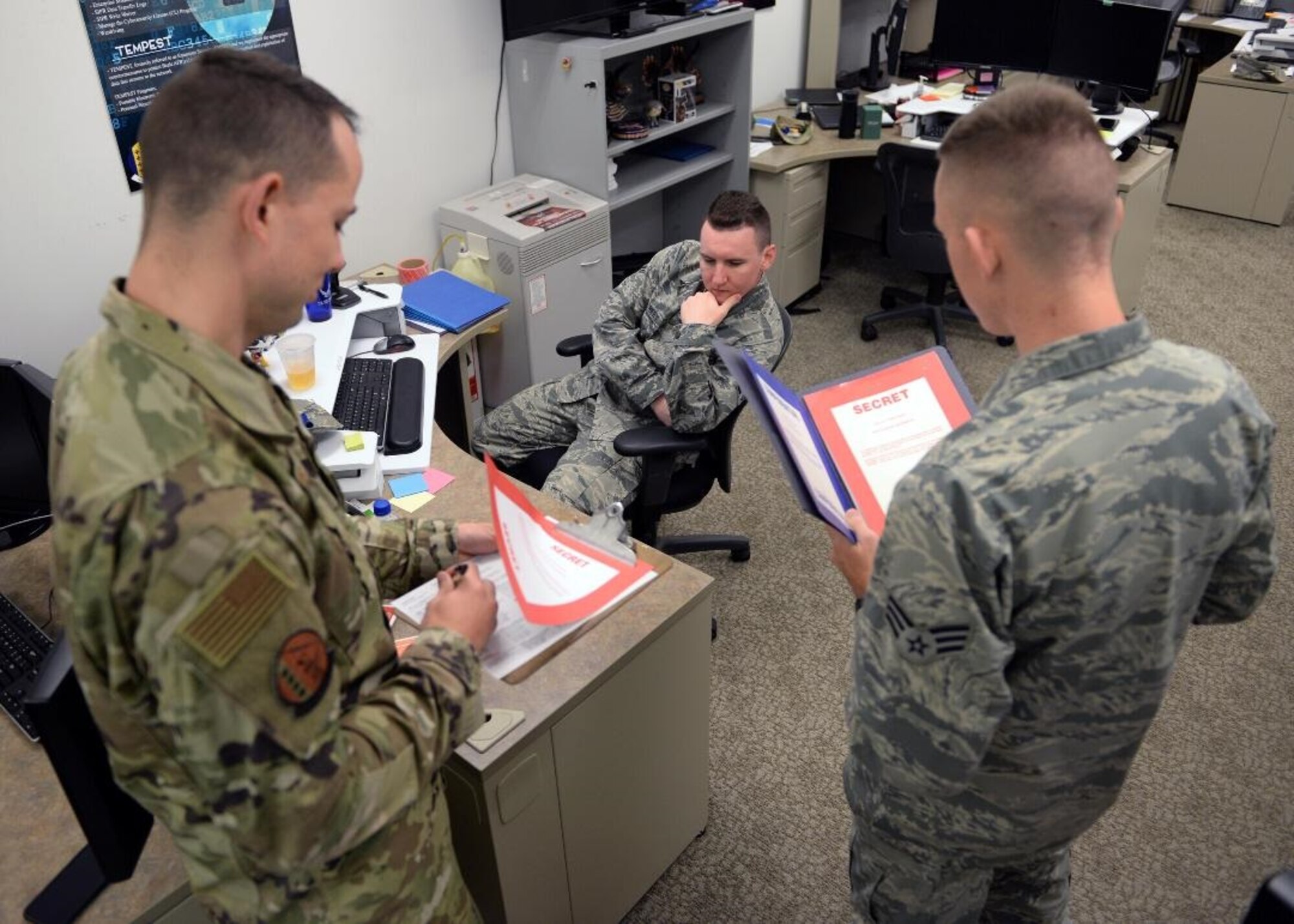 9th Communications Squadron cybersecurity Airmen conduct a simulated inspection in the cybersecurity office, on Beale Air Force Base, Oct. 17, 2019. Performing inspections is a part of how cybersecurity Airmen maintain a safe cyber environment. (U.S. Air Force photo by Airman Jason W. Cochran)