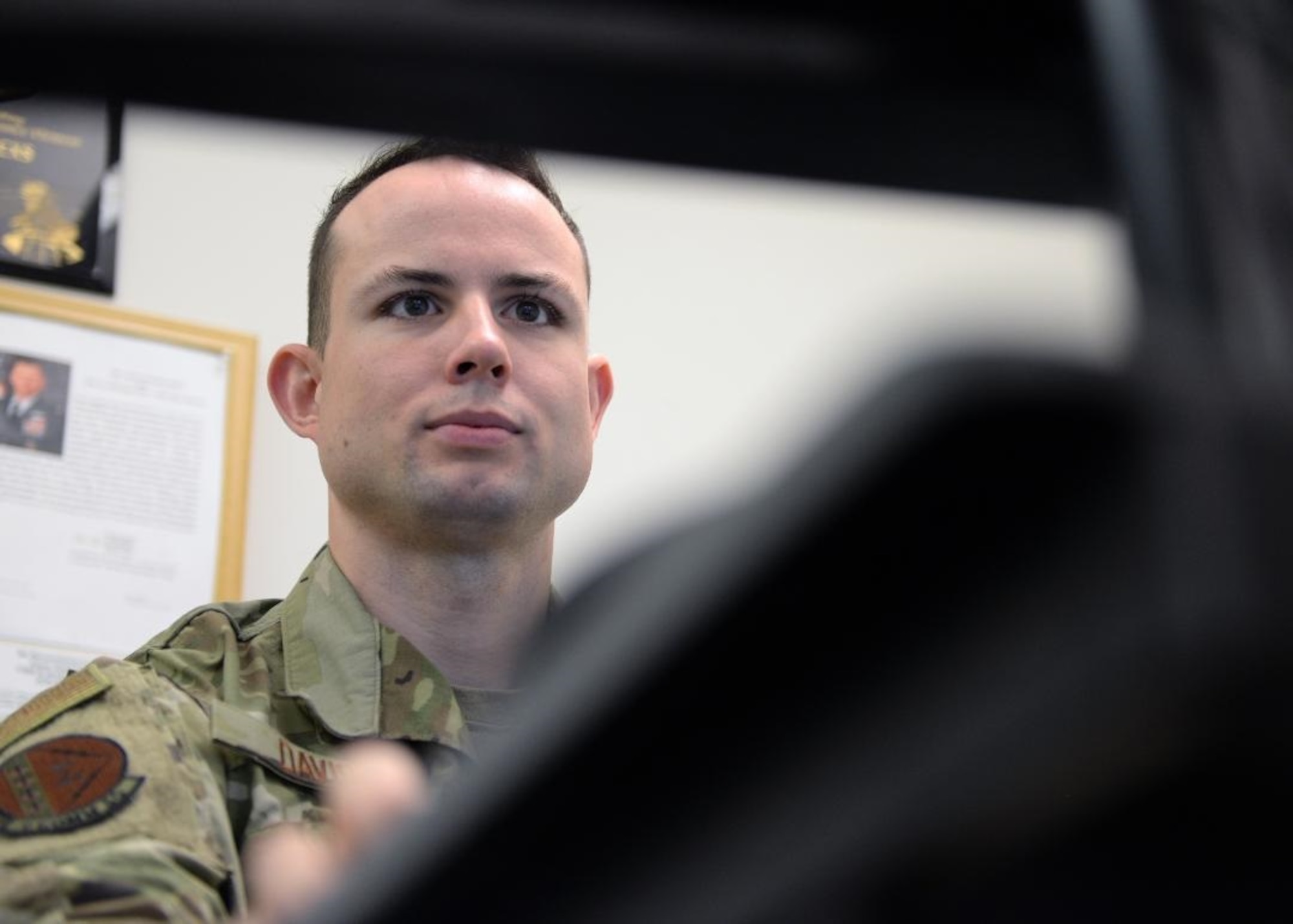 Senior Airman Daniel M. Davis, 9th Communications Squadron information system security officer, looks at a computer in the cybersecurity office, on Beale Air Force Base, Oct. 17, 2019. Cybersecurity Airmen have to manage more than 1,100 controls to maintain the risk management framework. (U.S. Air Force photo by Airman Jason W. Cochran)
