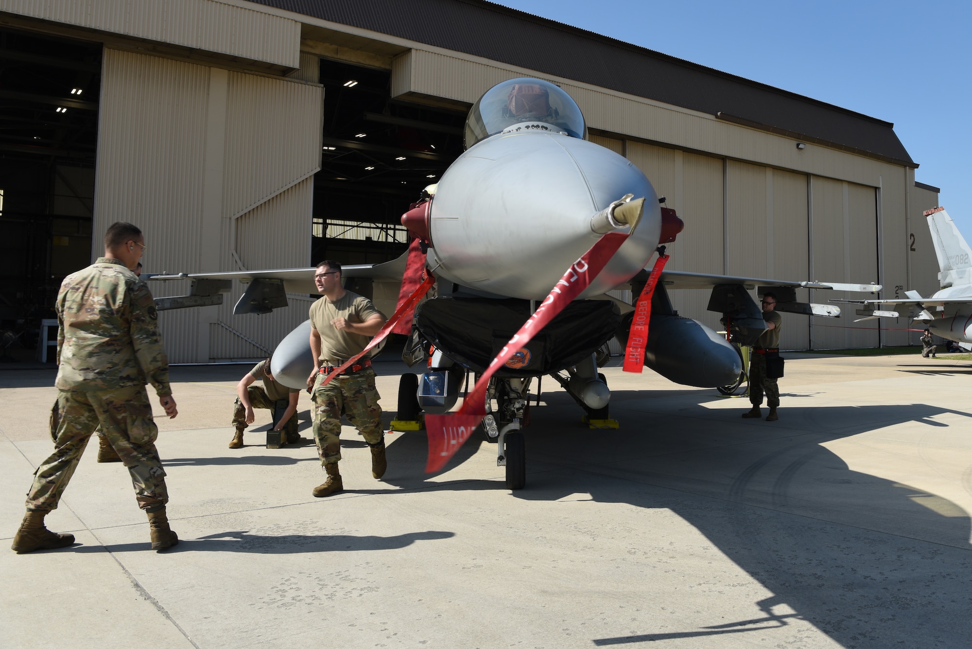Members of the 36th Aircraft Maintenance Unit prepare an F-16 Fighting Falcon aircraft for munitions during the 2019 Penn Fest competition at Kunsan Air Base, Republic of Korea, Oct. 19, 2019. The 36th and 25th AMUs came from Osan Air Base, ROK, to compete against the three teams at Kunsan. (U.S. Air Force photo by Staff Sgt. Joshua Edwards)