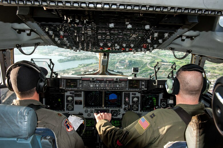 The skies aligned for two pilots and former college football players who were able to support their alma maters in a once-in-a-lifetime way on game day. Maj. Britton Komine, 204th Airlift Squadron, and Capt. Nathaniel Dreslinski, 535th Airlift Squadron, flew the C-17 Globemaster III over Aloha Stadium Saturday, Oct. 19, to demonstrate the power of the Air Force’s most flexible cargo aircraft at the U.S. Air Force Academy versus the University of Hawaii football game.