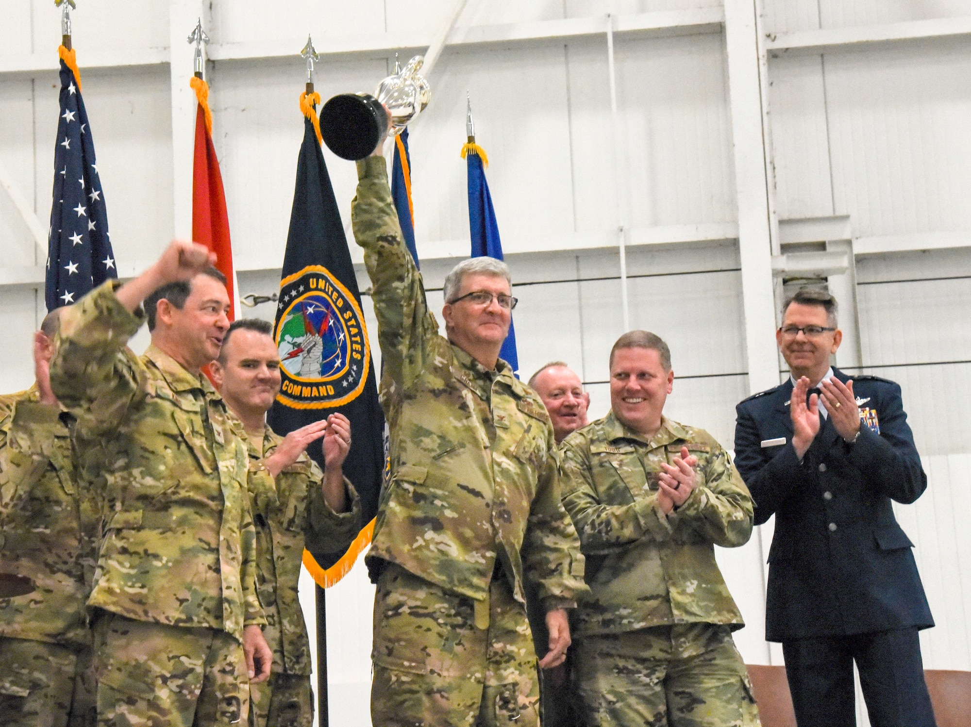 Col. Robert "Scott" Grant, commander, 117 Air Refueling Wing, hoists the Omaha Trophy in front of the 117 ARW at Sumpter Smith Air National Guard Base, AL., Oct. 19, 2019.  The 117 ARW was the first Air National Guard tanker unit to receive the award having won it in the startegic aircraft category.  (U.S. Air National Guard photo by Master Sgt. Jeremy Farson)