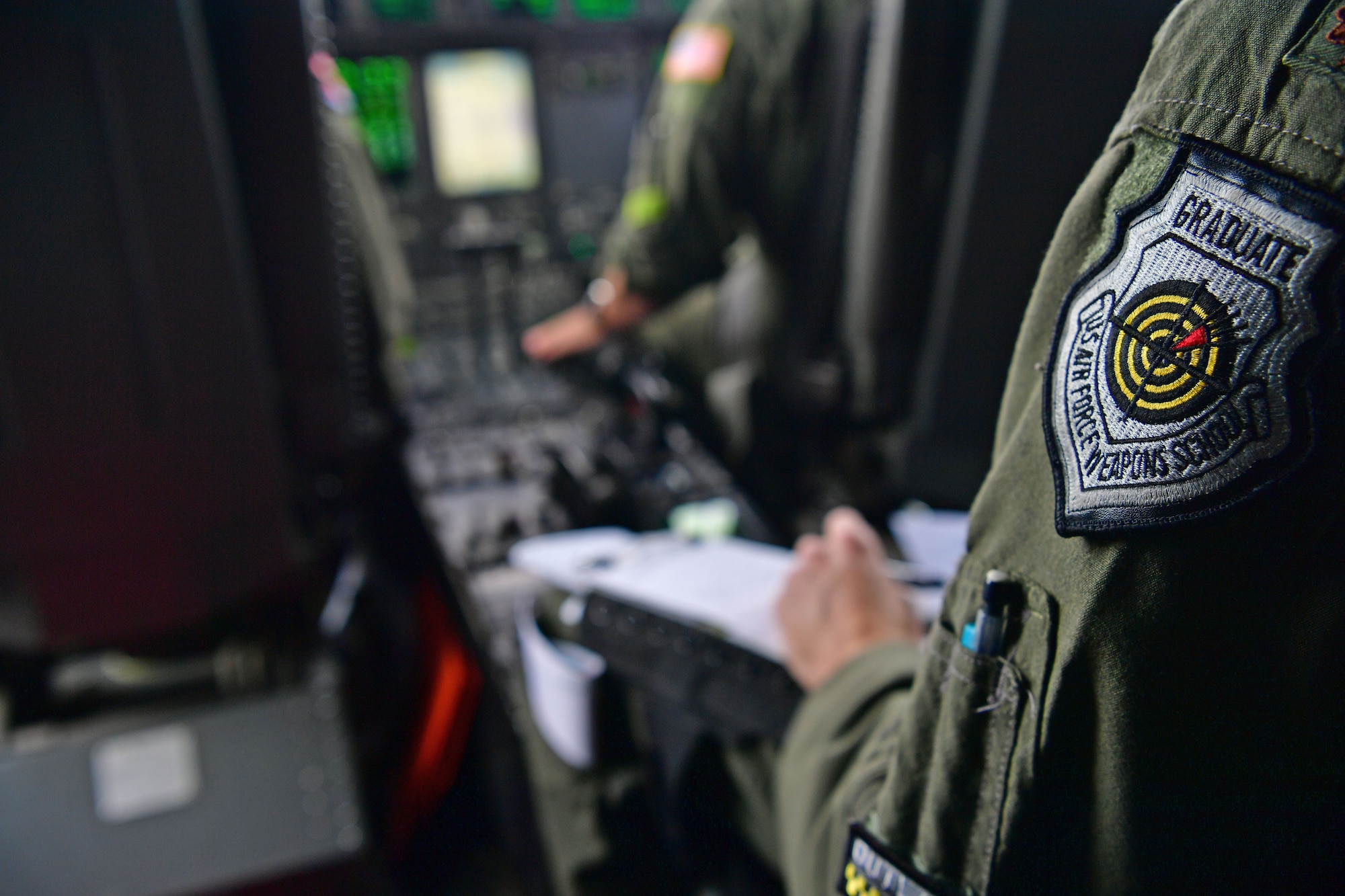 An instructor observes the weapons undergraduate pilots.