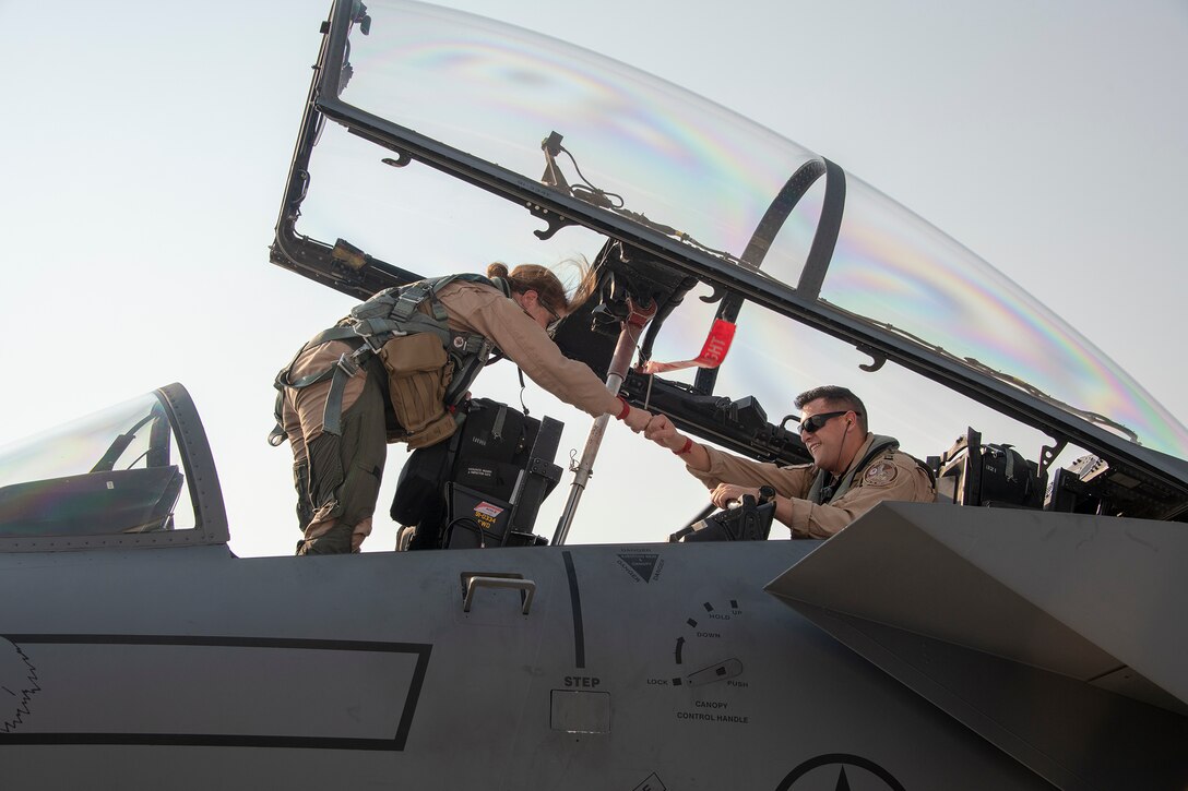 Lt. Col. Jaina Donberg, 494th Fighter Squadron commander, fist bumps Capt. “Sith” Lombardo, 494th FS weapons system officer, Oct. 21, 2019, after arriving at Al Dhafra Air Base, United Arab Emirates.