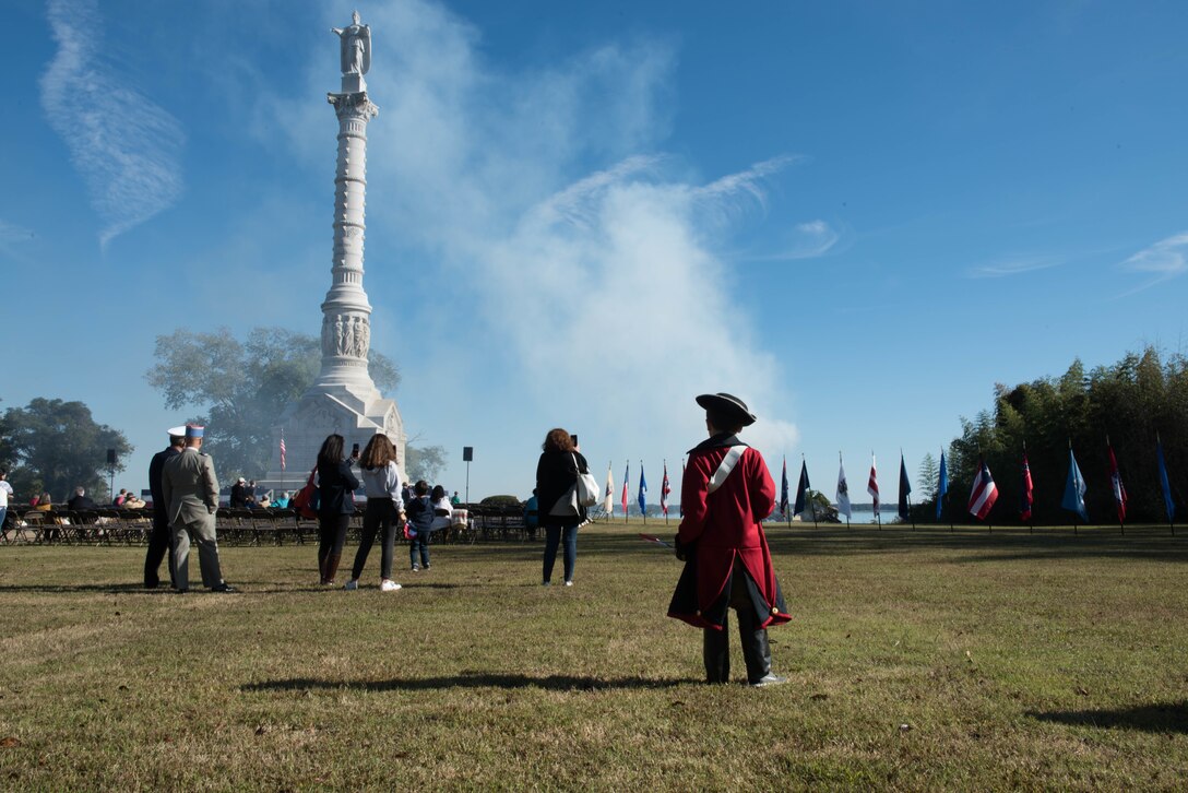 A young re-enactor watches as smoke from replica cannons drifts past the Yorktown Victory Monument at the annual Yorktown Day Parade at the Yorktown Battlefield, Virginia, Oct. 19, 2019. The monuments cornerstone was laid Oct. 18, 1881 and was completed Aug. 12, 1884. (U.S. Air Force photo by Airman 1st Class Sarah Dowe)