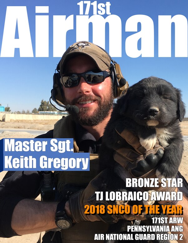 Master Sergeant Keith Gregory poses with a dog during a deployment to Afghanistan