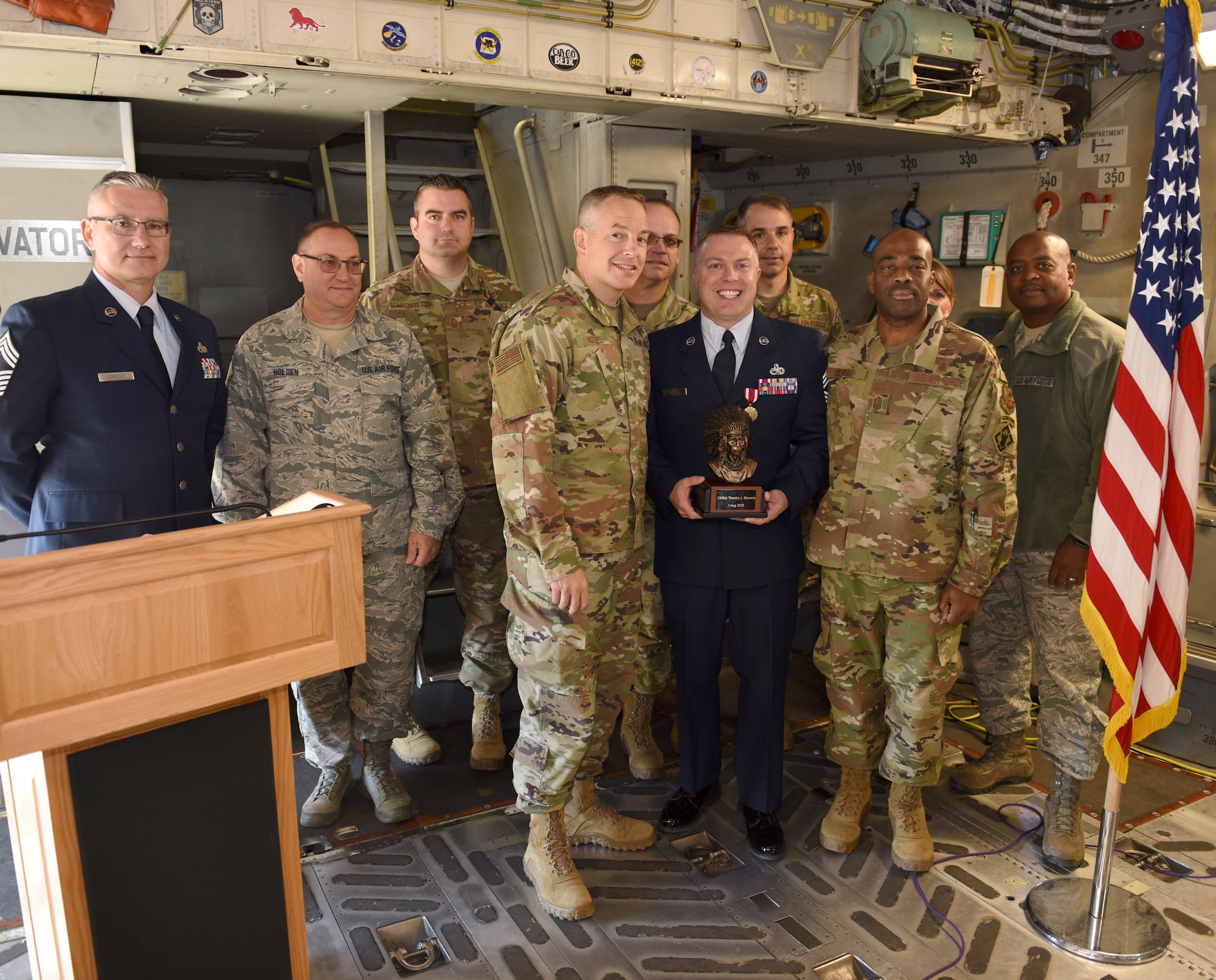 Chief Master Sgt. Timothy J. Stevens of the 911th Maintenance Group receives the Chiefs’ Bust presented to him by 911th Airlift Wing Command Chief Master Sgt. Christopher D. Neitzel on behalf of the 911th AW Chiefs' Council during a chief’s induction ceremony at the Pittsburgh International Airport Air Reserve Station, Pennsylvania, Oct. 5, 2019.